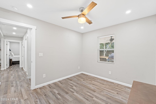 spare room featuring light hardwood / wood-style floors and ceiling fan