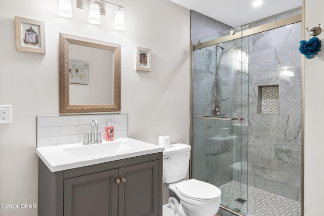 bathroom featuring vanity, toilet, and an enclosed shower