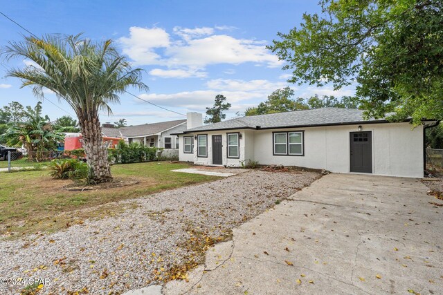 ranch-style home featuring a front yard