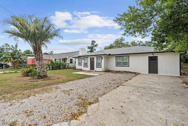 ranch-style house with a front lawn