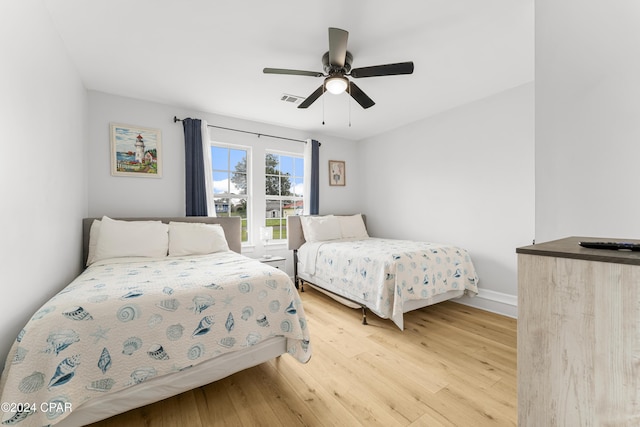 bedroom with light wood-type flooring and ceiling fan