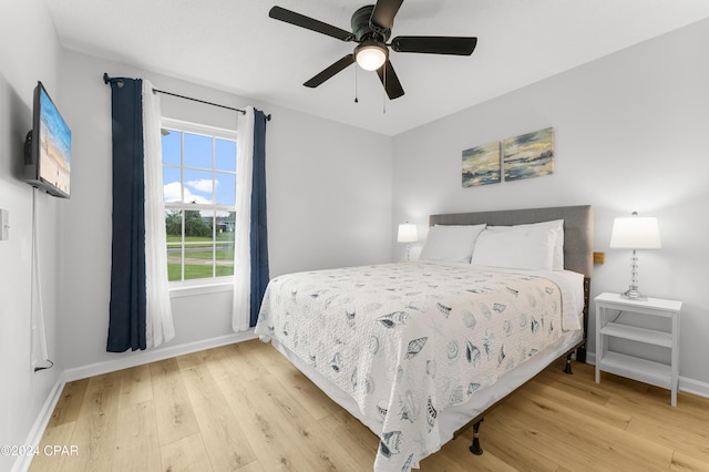 bedroom with ceiling fan and light hardwood / wood-style floors