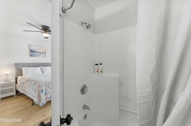 bathroom with ceiling fan, shower / tub combo, and hardwood / wood-style floors