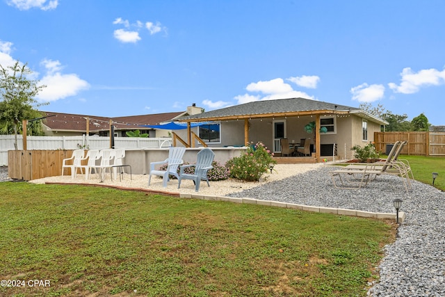 back of house with a lawn and a patio area