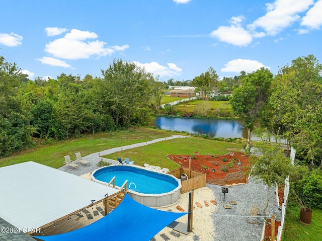 view of swimming pool with a lawn and a water view