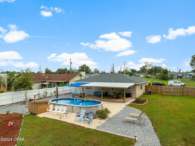 view of pool featuring a lawn and a patio