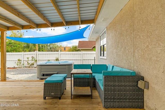 wooden deck with a hot tub and outdoor lounge area