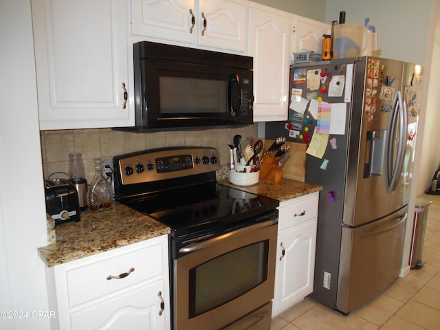 kitchen featuring dark stone countertops, backsplash, white cabinets, and appliances with stainless steel finishes