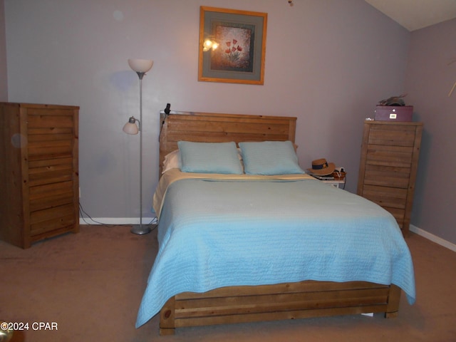 bedroom featuring lofted ceiling and carpet flooring