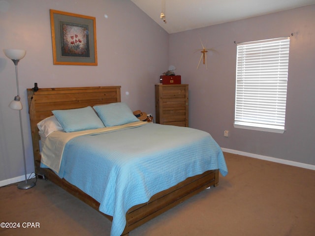 carpeted bedroom featuring lofted ceiling