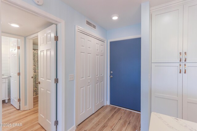 empty room featuring ceiling fan with notable chandelier and light hardwood / wood-style flooring