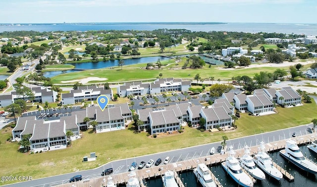 aerial view with golf course view and a water view