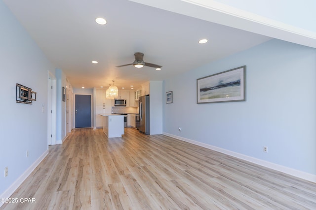 unfurnished living room with a ceiling fan, light wood-style floors, recessed lighting, and baseboards