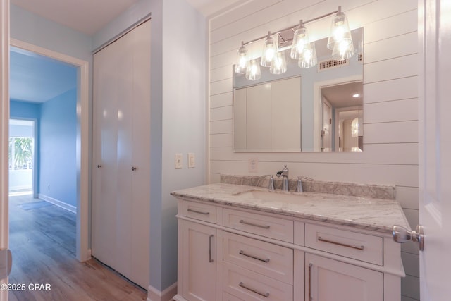 bathroom with vanity and hardwood / wood-style flooring