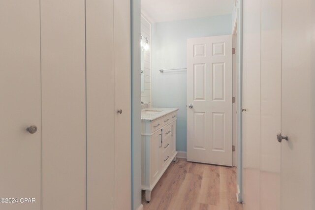 bathroom featuring wood-type flooring, a shower with shower curtain, vanity, and toilet