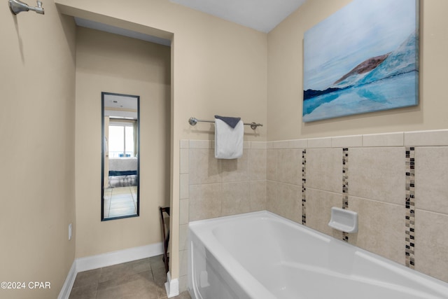 bathroom with a bathing tub and tile patterned flooring