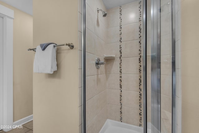 bathroom featuring tile patterned floors and a shower with door