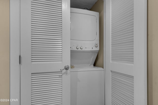 washroom with stacked washer and clothes dryer