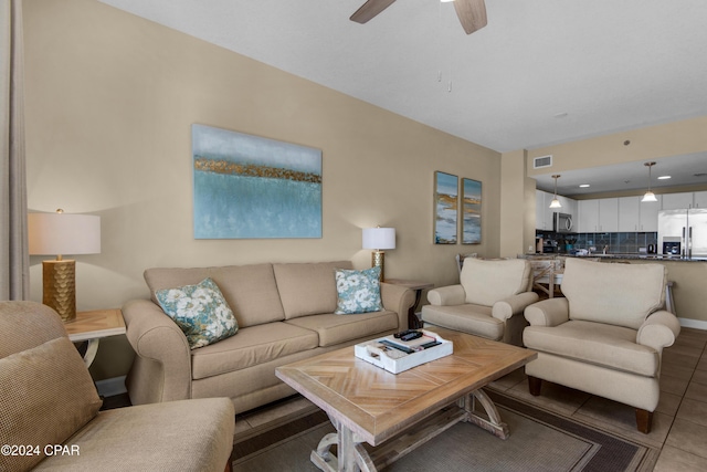 tiled living room with ceiling fan