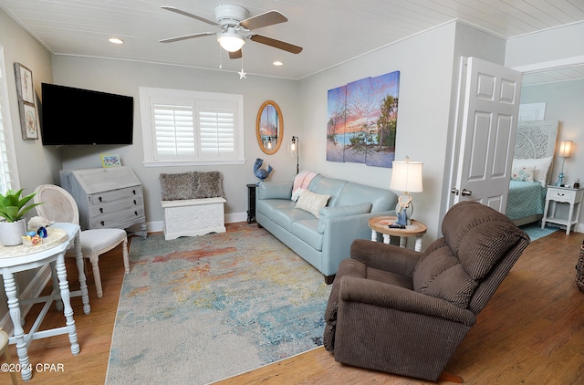 living room with hardwood / wood-style floors, ceiling fan, and wooden ceiling