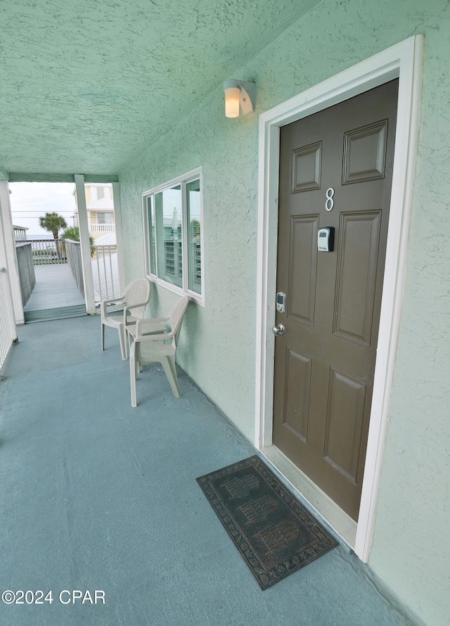 view of exterior entry with covered porch