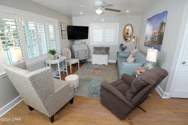 living room featuring ceiling fan, a healthy amount of sunlight, and light hardwood / wood-style flooring