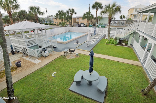 view of pool with a lawn