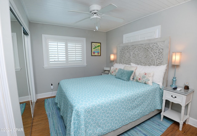 bedroom with hardwood / wood-style flooring, ceiling fan, wood ceiling, and a closet