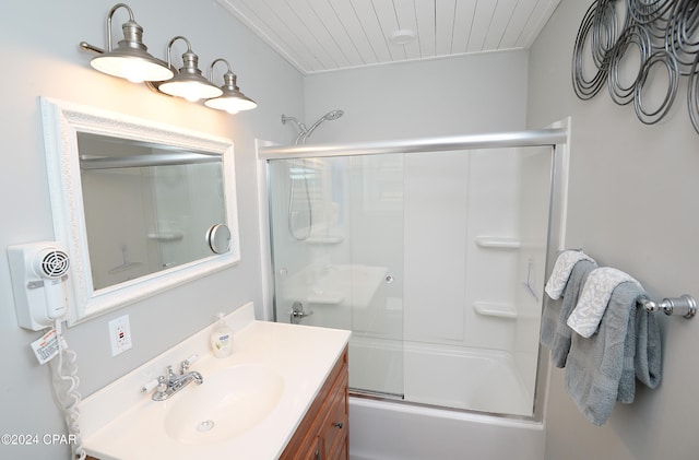 bathroom with vanity and shower / bath combination with glass door