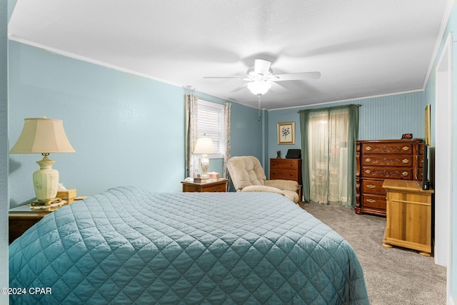 carpeted bedroom featuring ceiling fan and ornamental molding