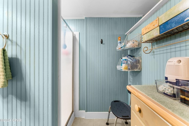 bathroom with tile patterned flooring and ornamental molding