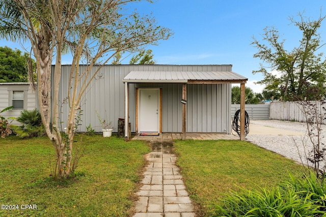 view of outbuilding featuring a lawn