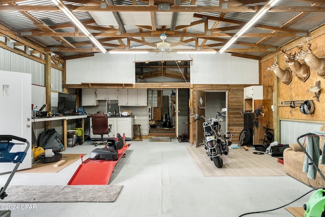 misc room with wooden walls and high vaulted ceiling