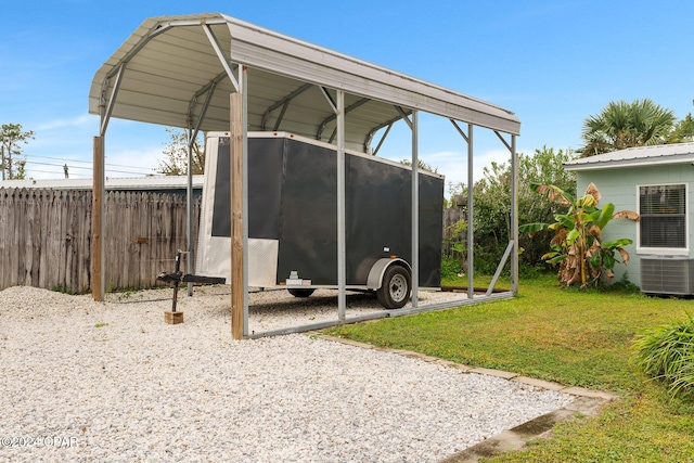 exterior space featuring a yard, central AC unit, and a carport