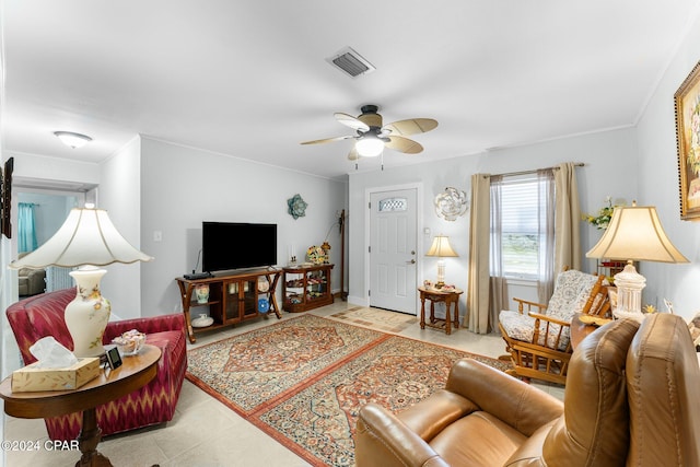 living room with ceiling fan and ornamental molding