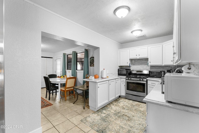 kitchen featuring stainless steel gas range, kitchen peninsula, decorative backsplash, white cabinets, and ornamental molding