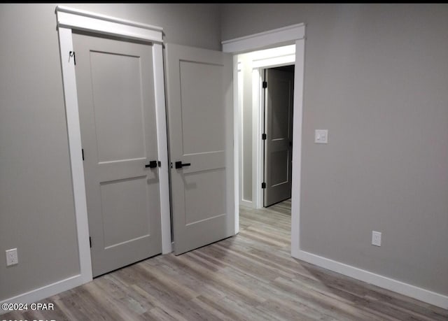 unfurnished bedroom with light wood-type flooring