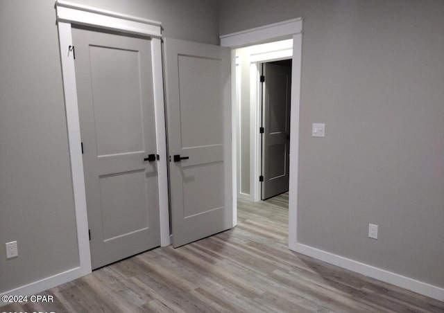 corridor with light hardwood / wood-style flooring