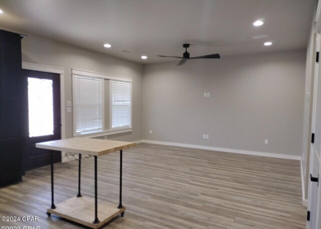 unfurnished dining area with ceiling fan and light hardwood / wood-style floors