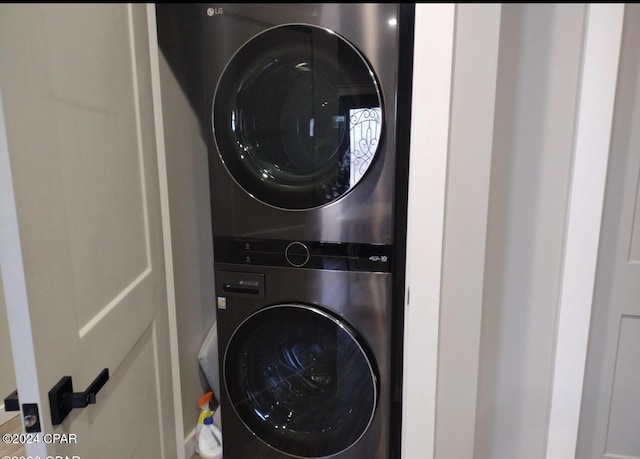 laundry room with stacked washer / dryer