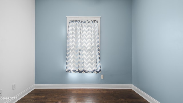 spare room featuring dark hardwood / wood-style flooring