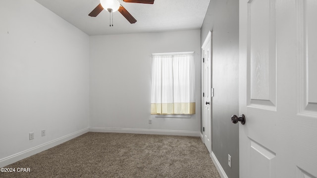 empty room with carpet and ceiling fan