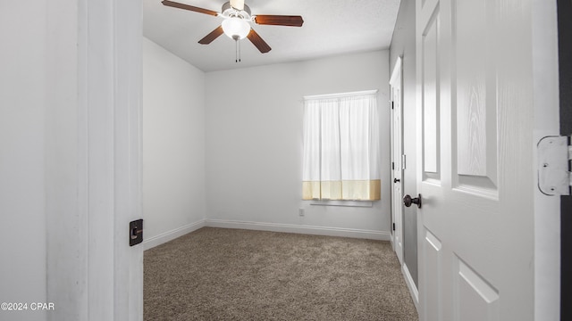 spare room with carpet flooring and ceiling fan