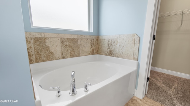 bathroom featuring a tub to relax in