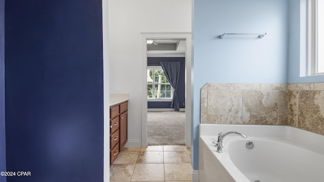 bathroom featuring vanity, tile patterned floors, and a bathtub