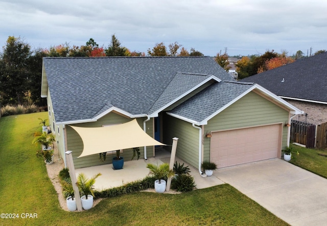 view of front of house featuring a garage and a front yard