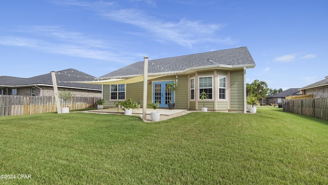 rear view of property with a lawn and a patio area