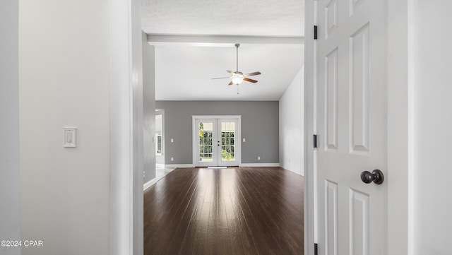 interior space featuring ceiling fan, wood-type flooring, a textured ceiling, and french doors