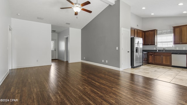 kitchen featuring ceiling fan, sink, stainless steel appliances, light hardwood / wood-style flooring, and high vaulted ceiling