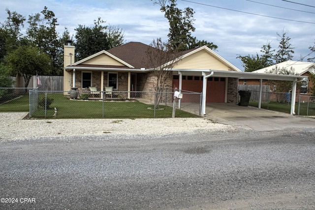 view of front of house with a front lawn, covered porch, and a carport